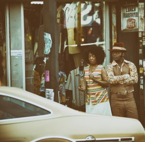 Man and Woman Standing Near Beige Vehicle